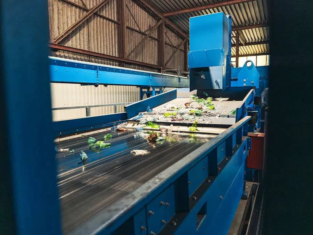 Plastics for recycling moving on conveyor in large sorting machine