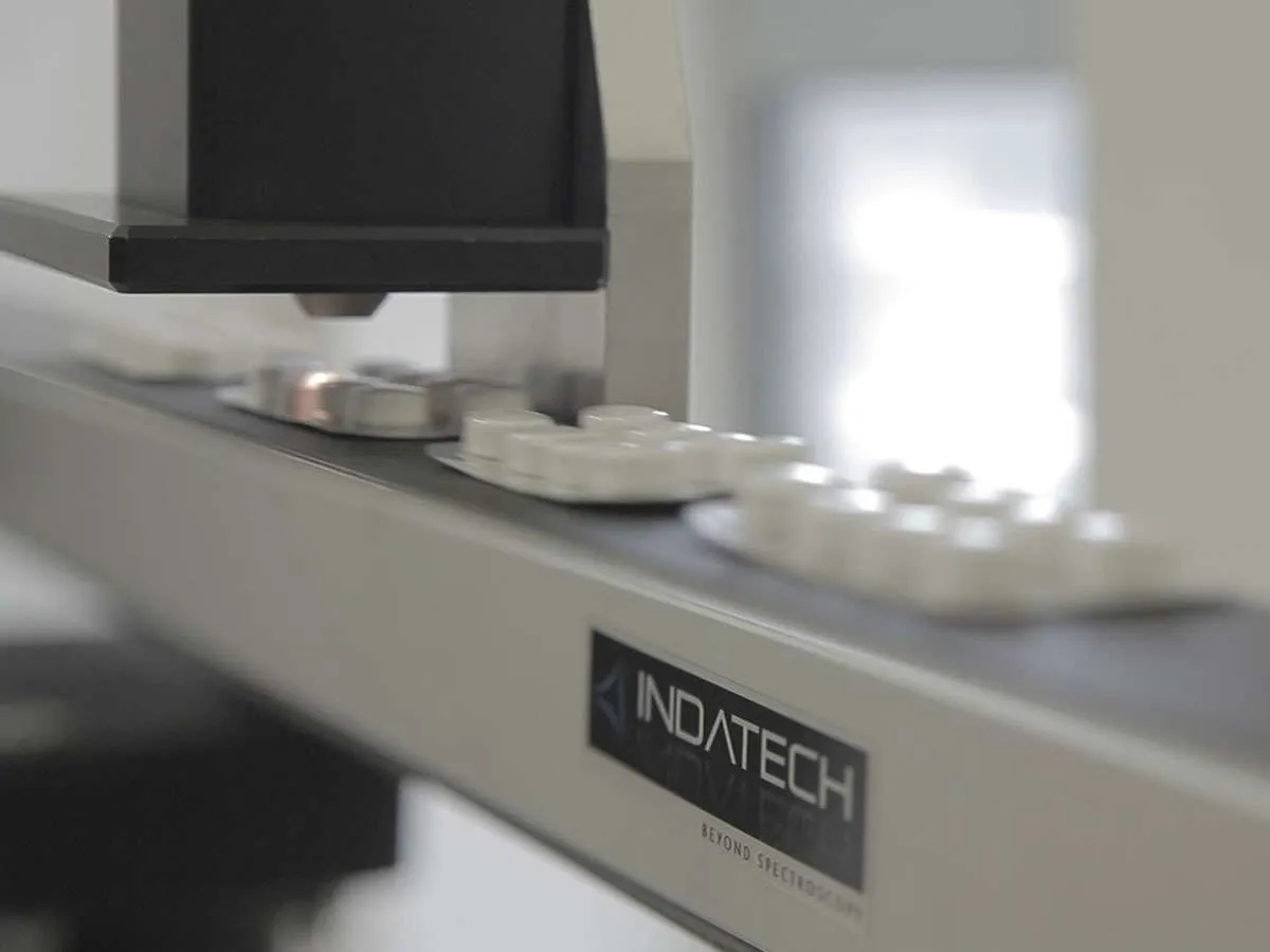 Sensor above moving conveyor imaging pharmaceutical capsules in blister packs