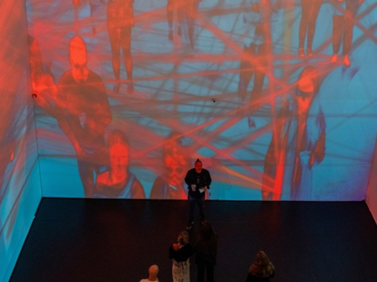 Image of spectral subjects installation with viewers standing in front