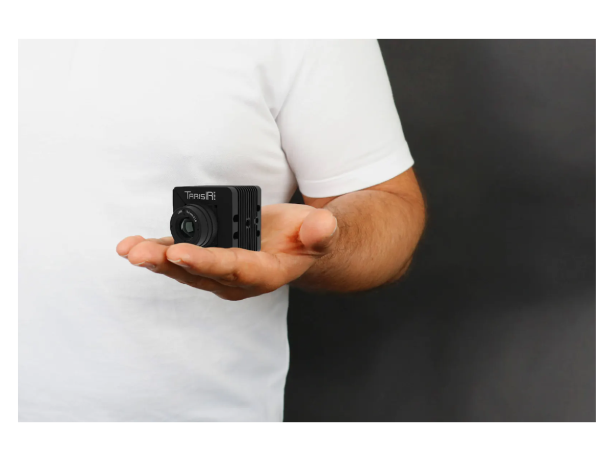InfraTec TarisIR mini 600 camera held in someone's palm showing small, compact design