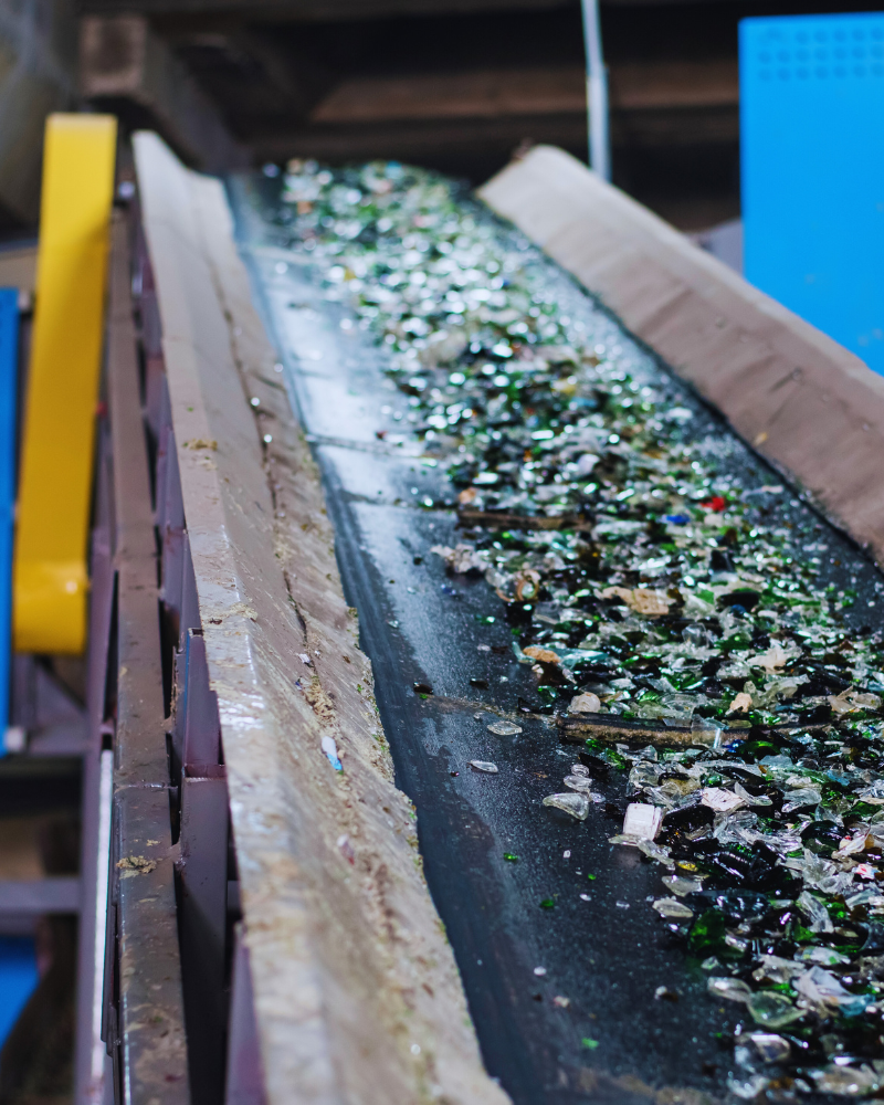 Glass shards moving along a conveyor belt in a sorting facility